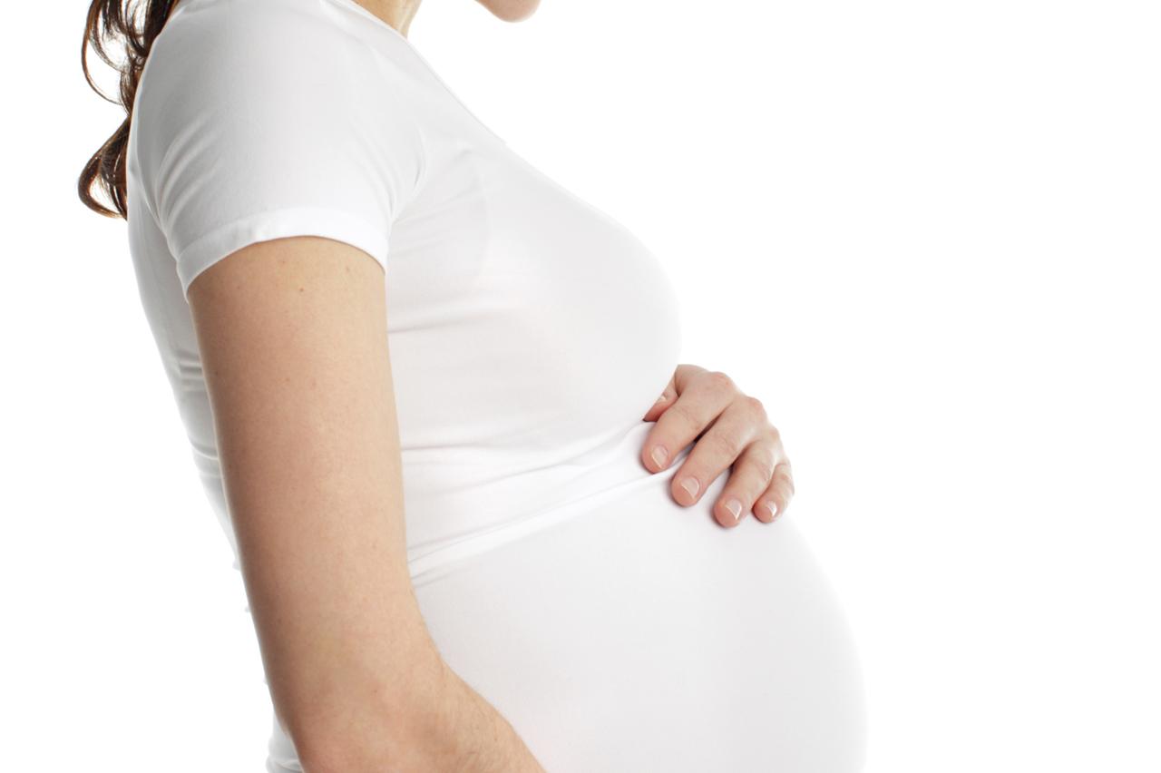 Pregnant beautiful woman isolated on white