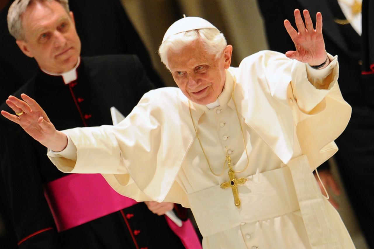 'Pope Benedict XVI waves as he arrives for an audience with youths of Madrid archidiocese who took part in the 2011 World Youth Day celebration in the Spanish capital on April 2, 2012 at Paul VI hall 