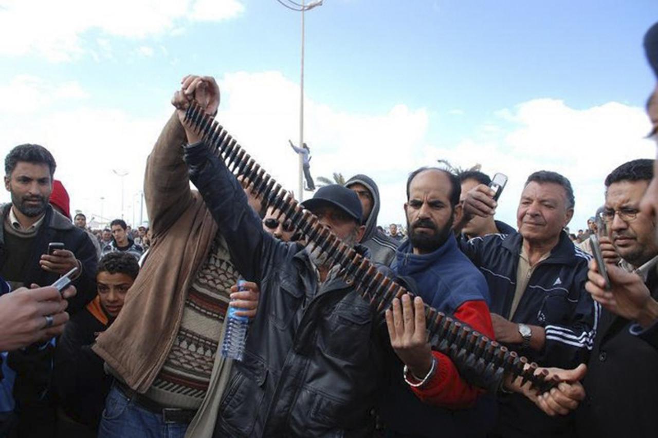 \'A Libyan man holds up a belt of bullets in this undated picture made available on Facebook February 20, 2011. The image was purportedly taken recently in Benghazi. REUTERS/Handout (LIBYA - Tags: POL
