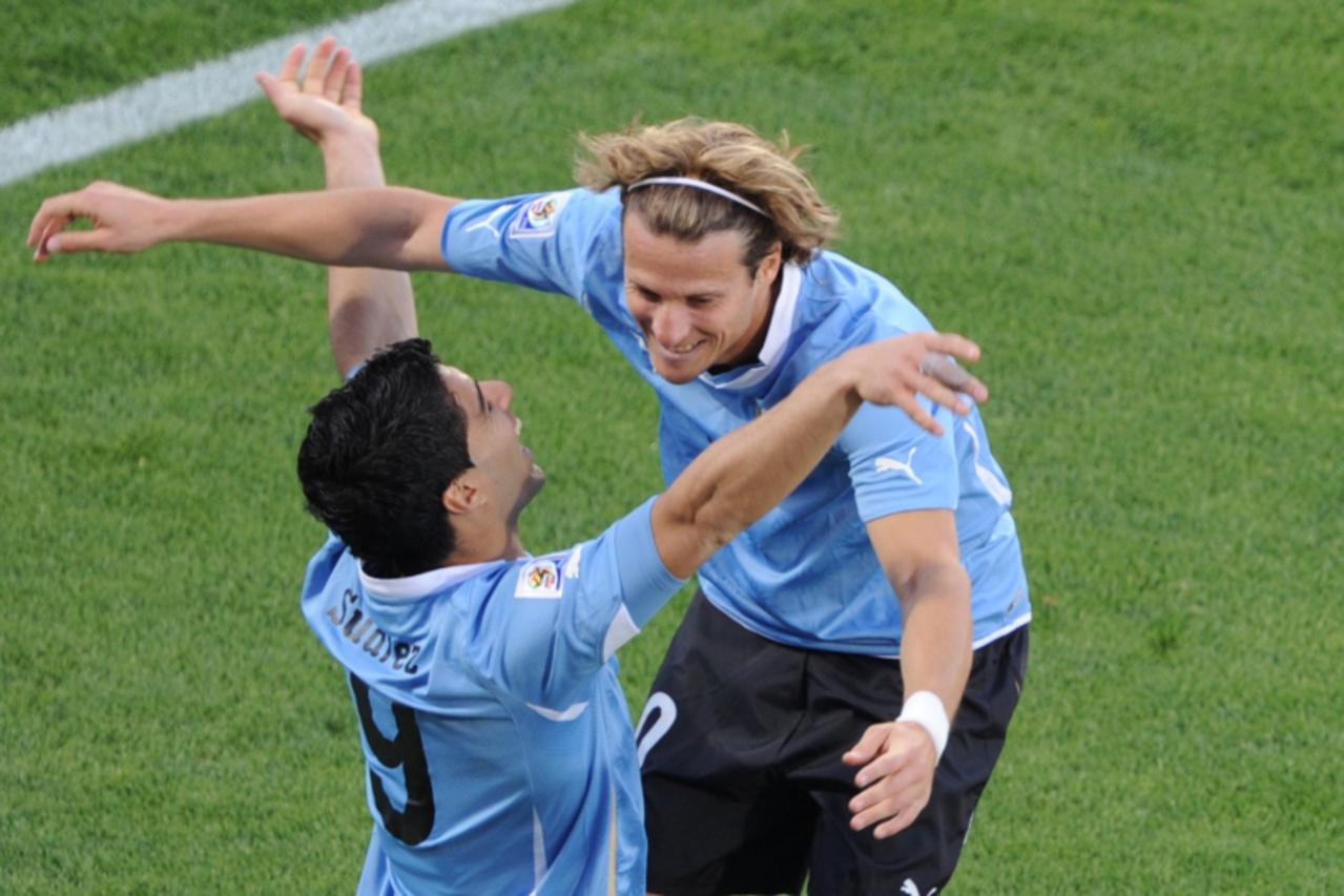 'Uruguay\'s striker Luis Suarez (L) celebrates with striker Diego Forlan after scoring against Mexico during the Group A first round 2010 World Cup football match on June 22, 2010 at Royal Bafokeng st