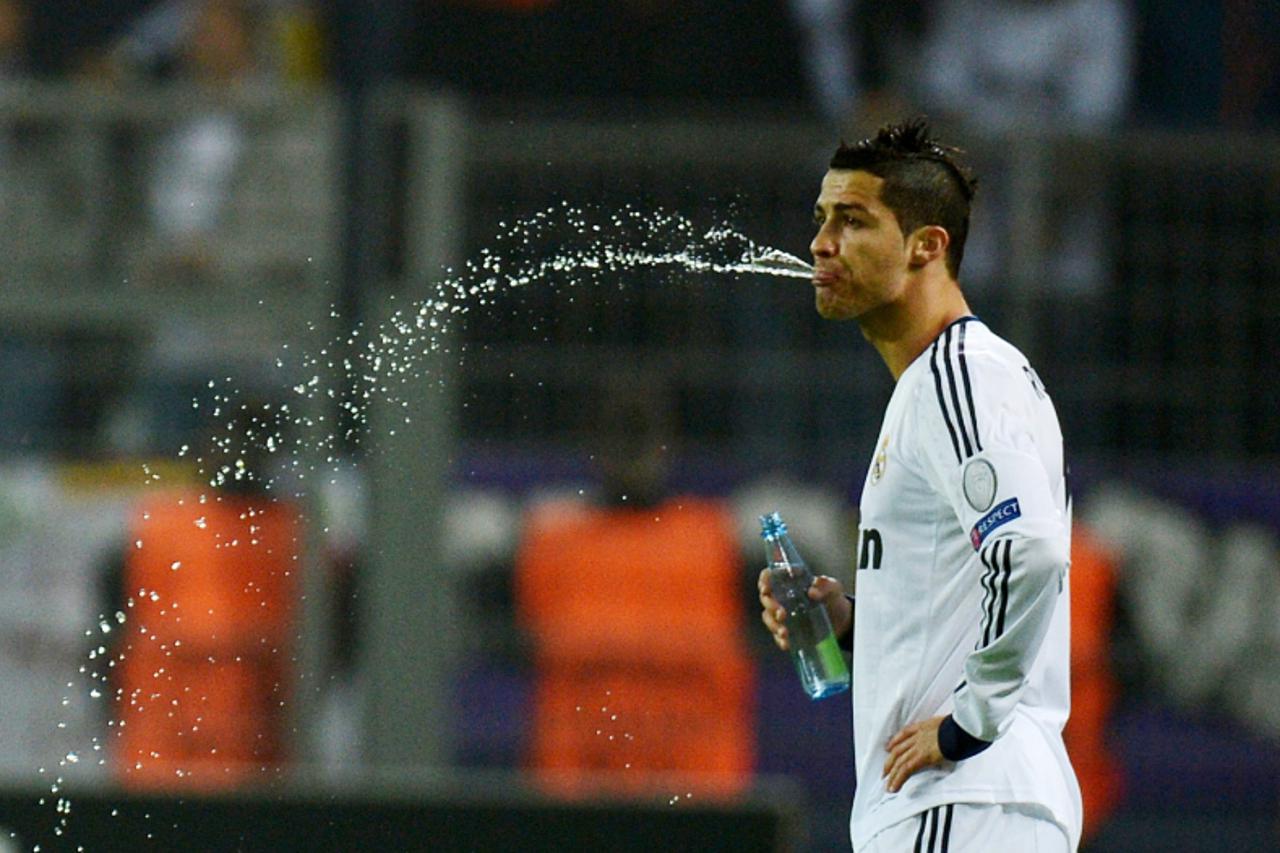 'Real Madrid's Portuguese forward Cristiano Ronaldo spits water prior to the UEFA Champions League Group D football match BVB Borussia Dortmund vs Real Madrid in Dortmund, western Germany on October 