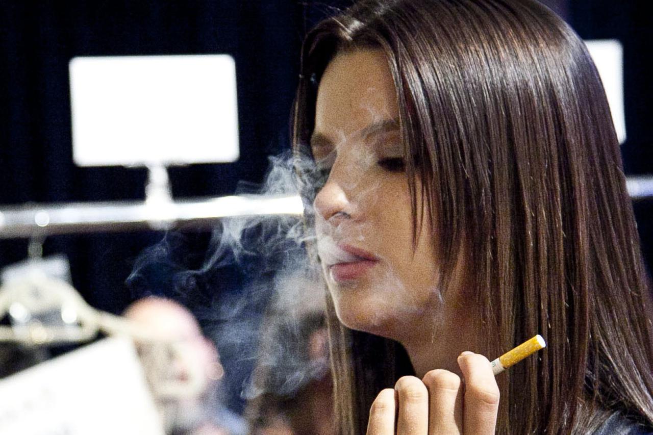 NEW YORK, NY - SEPTEMBER 11:  A model smoke an E cigarette backstage at the Rolando Santana fashion show during Mercedes-Benz Fashion Week Spring 2014 at Center 548 on September 11, 2013 in New York City.  (Photo by Allison Joyce/Getty Images)