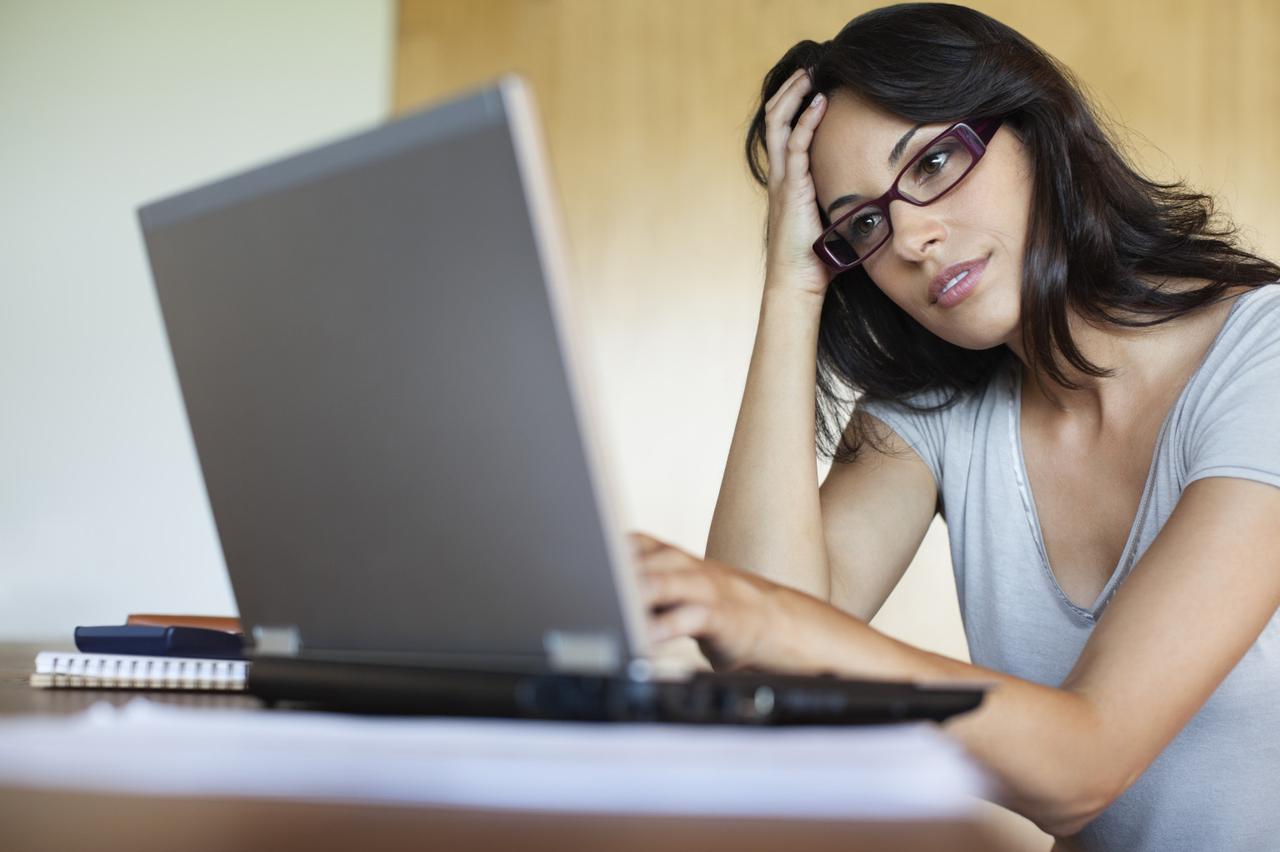 Frustrated woman using laptop