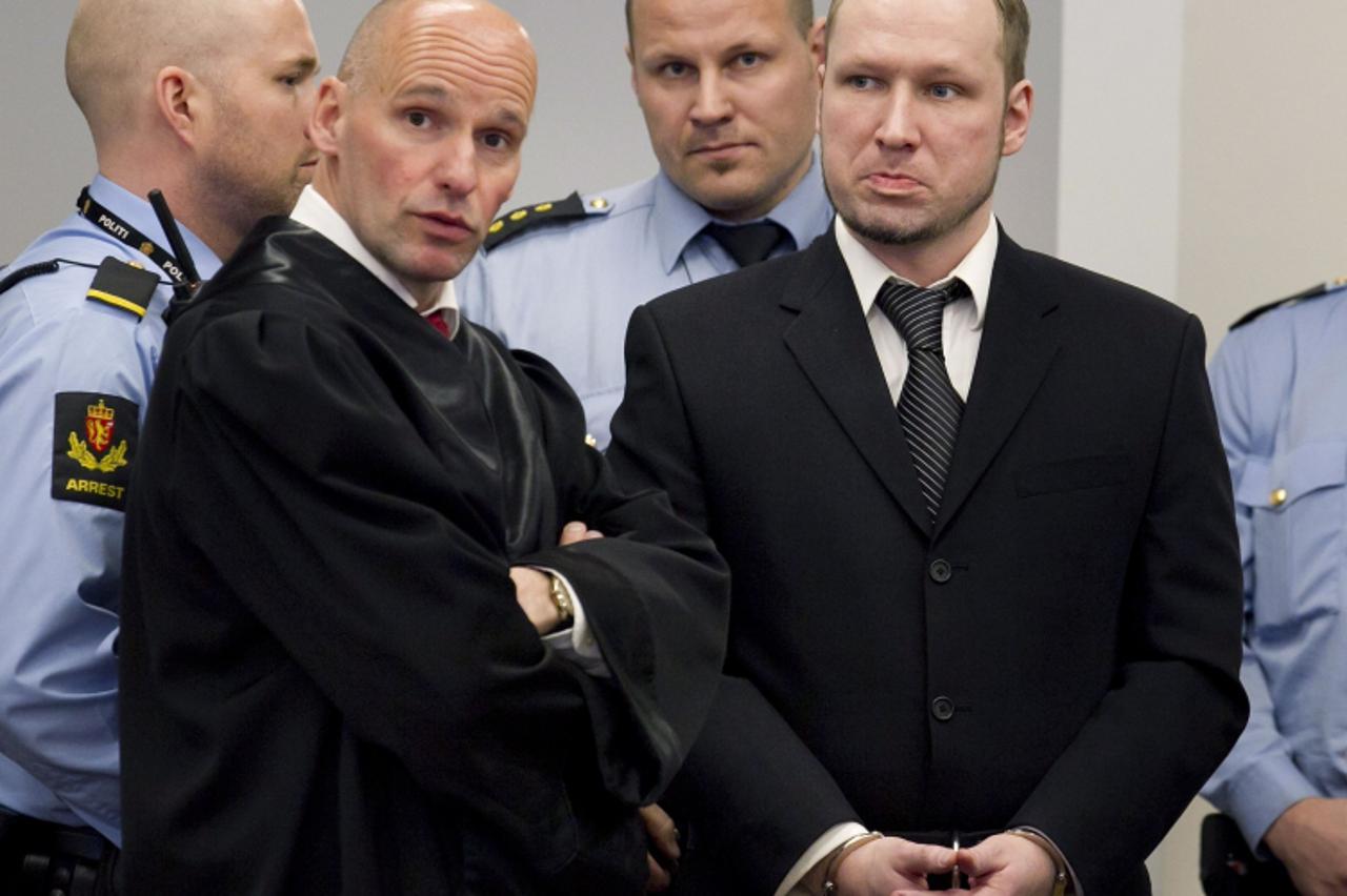 'Defendant Anders Behring Breivik (R) is seen with his lawyer Geir Lippestad during the third day of proceedings in the courthouse in Oslo April 18, 2012.  REUTERS/Heiko Junge/Scanpix Norway/Pool (NOR