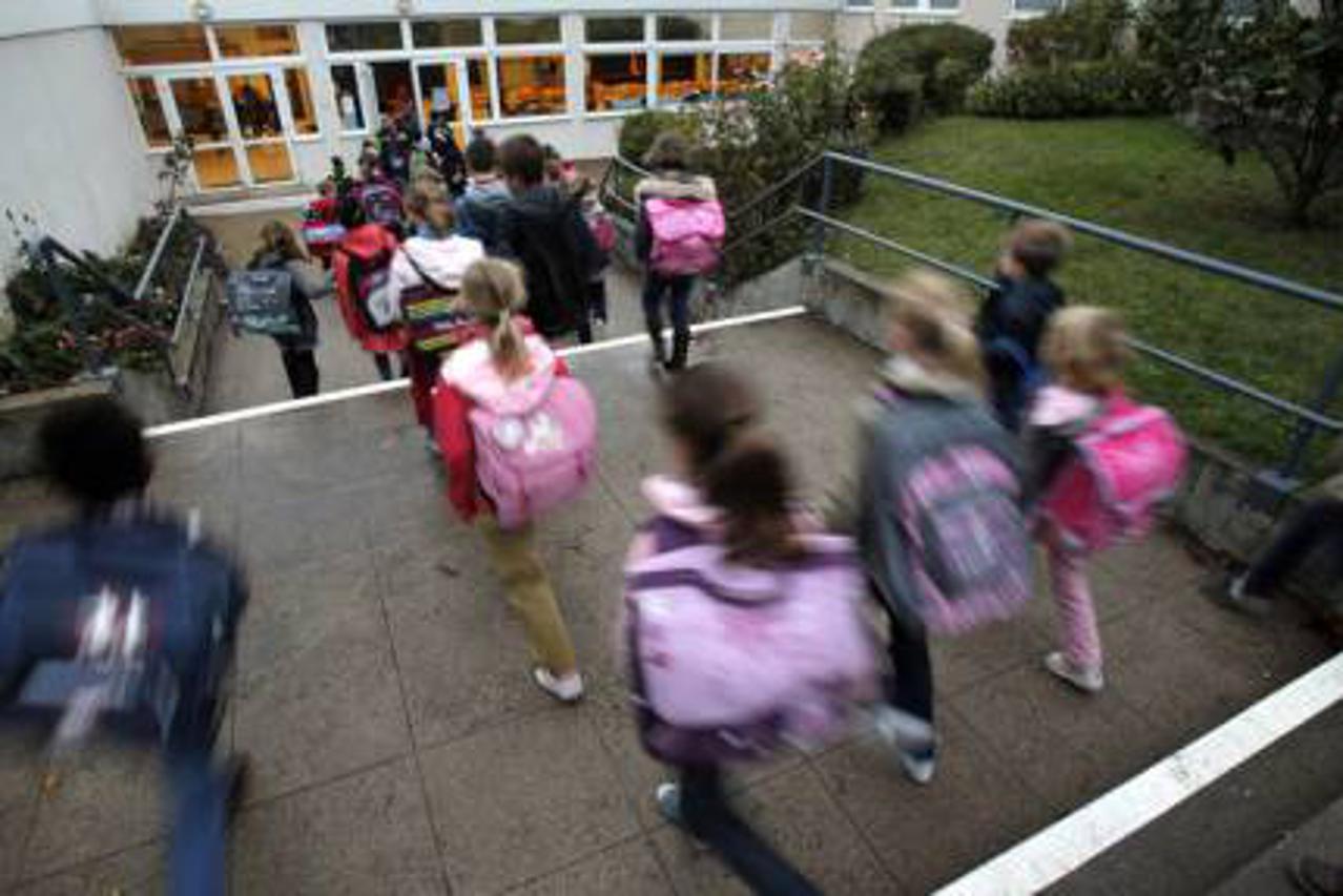 FILE - In this Oct. 5, 2012 file photo, students enter school of La Ronce in Ville d'Avray, west of Paris. France’s government has unveiled Wednesday Aug. 24, 2016 a plan to teach children how to react in case of an attack at school. Every school will hav