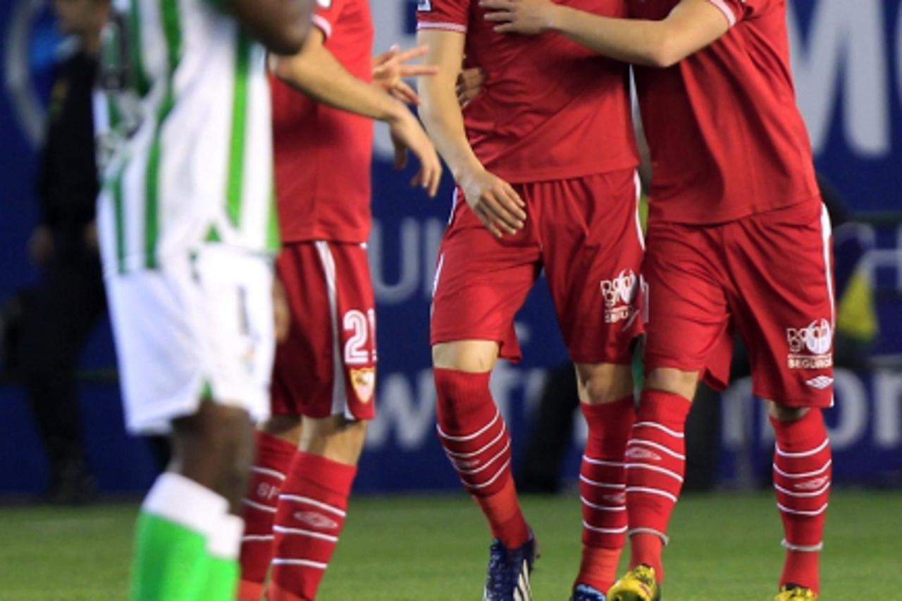 'Sevilla's Ivan Rakitic (R) is congratulated by Alvaro Negredo after scoring against Real Betis during their Spanish first division soccer match at Benito Villamarin stadium in Seville April 12, 2013