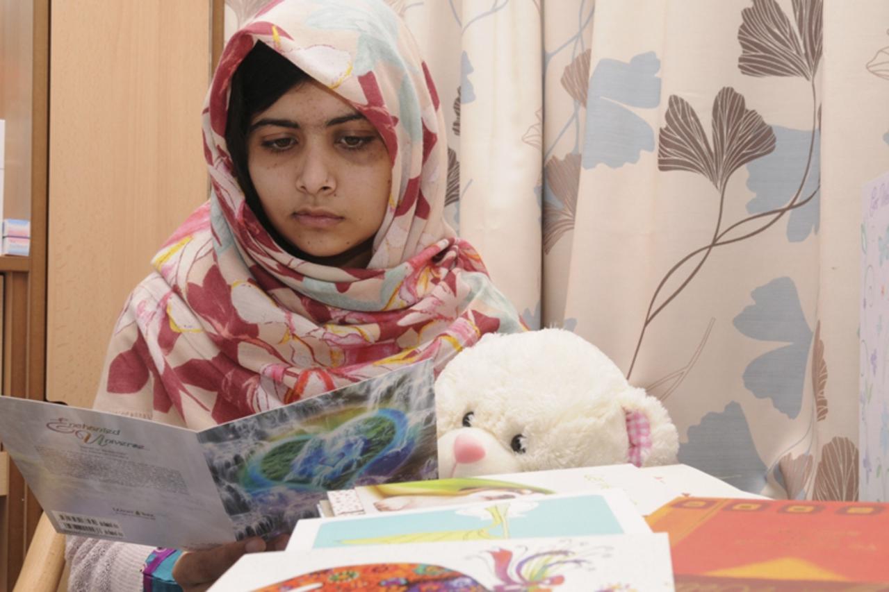 'Pakistani schoolgirl Malala Yousufzai reads a card as she recuperates at the The Queen Elizabeth Hospital in Birmingham, in this undated handout photograph released to Reuters on November 8, 2012. Ma