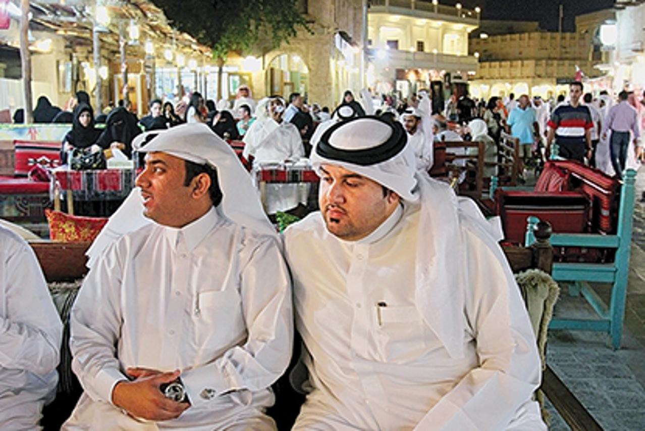 '09 Apr 2010, Doha, Qatar --- Qatari men eat dinner at a restaurant in Doha, Qatar. --- Image by © Shawn Baldwin/Corbis'