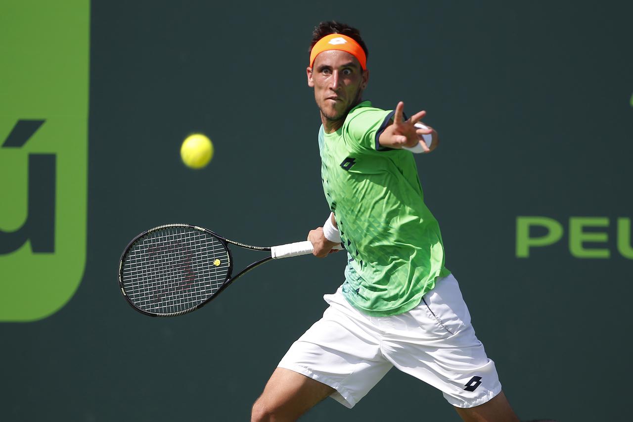 Mar 26, 2016; Key Biscayne, FL, USA; Damir Dzumhur hits a forehand against Rafael Nadal (not pictured) on day five of the Miami Open at Crandon Park Tennis Center. Dzumhur won 2-6, 6-4, 3-0 (ret.). Mandatory Credit: Geoff Burke-USA TODAY Sports
