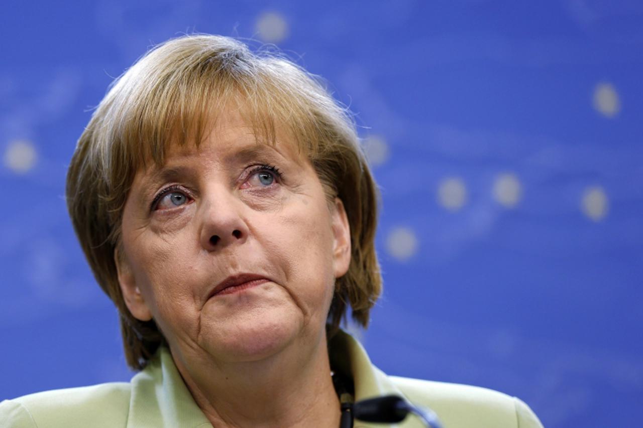 'Germany\'s Chancellor Angela Merkel addresses a news conference during a European Union leaders summit in Brussels June 28, 2013. European Union leaders confirmed on Friday they want agreement by the