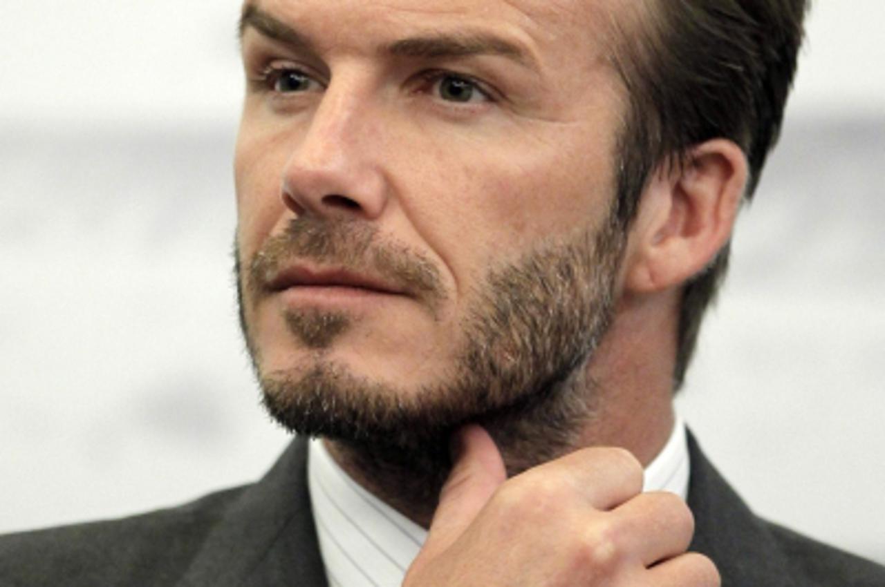 'Former England soccer captain David Beckham addresses a news conference in Shanghai June 20, 2013. Beckham arrived in China on Monday to start his second trip as China's soccer envoy. REUTERS/Aly So