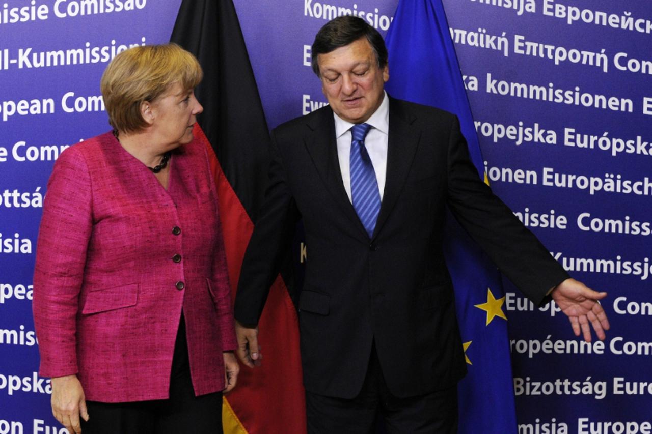 'European Commission President Jose Manuel Barroso (R) welcomes German Chancellor Angela Merkel prior to their meeting at the EU headquarters in Brussels on October 5, 2011. Angela Merkel holds talks 