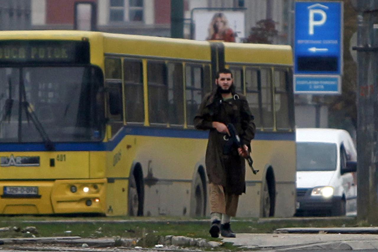 A gunman with an automatic weapon walks in Sarajevo, after he fired shots at the U.S. embassy, October 28, 2011. The gunman with an automatic weapon opened fire at the United States embassy in the Bosnian capital Sarajevo on Friday and police rushed to th