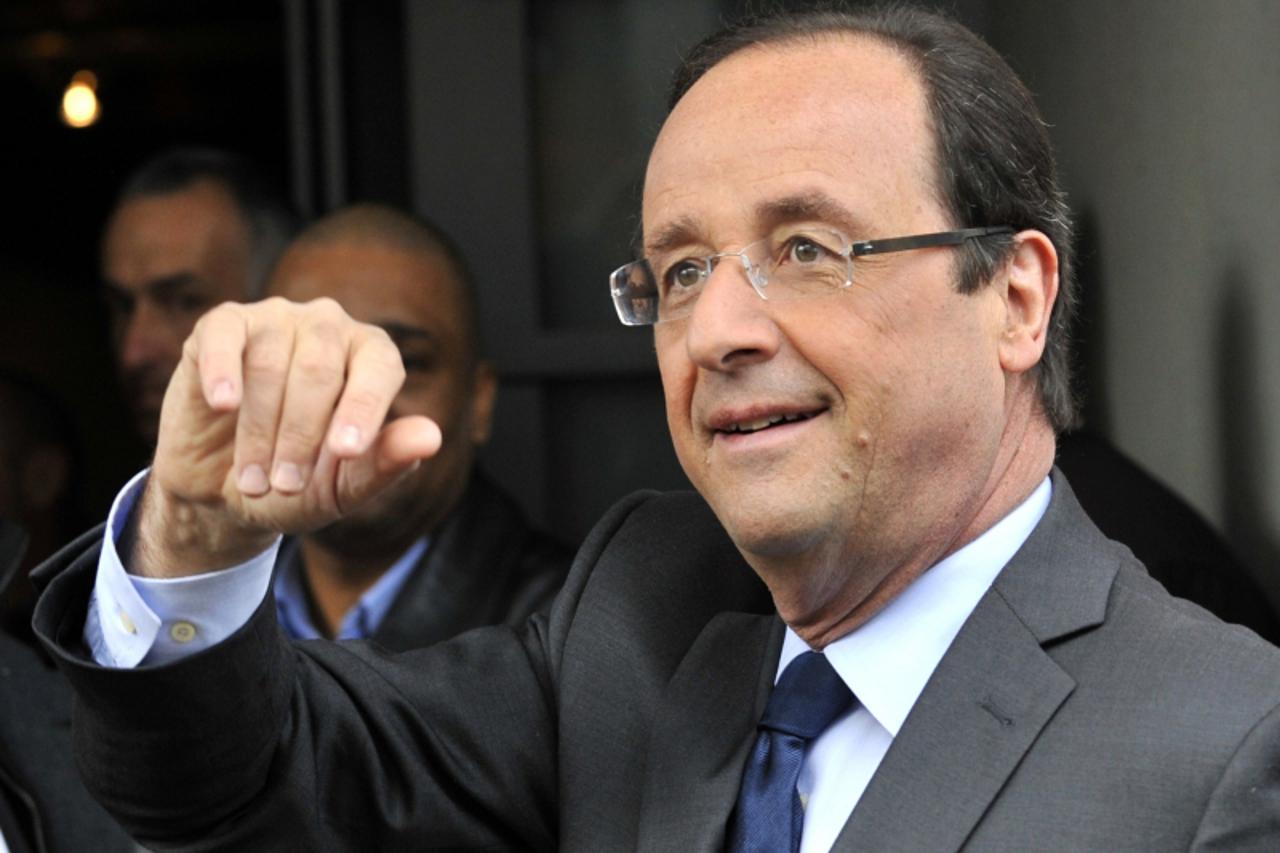 'France's opposition Socialist Party (PS) candidate Francois Hollande gestures after casting his ballot during the first round of the 2012 French Presidential election on April 22, 2012 in Tulle, cen