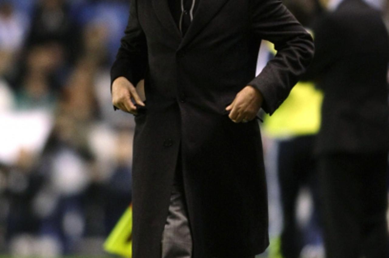 \'Real Madrid\'s coach Jose Mourinho reacts during their Spanish First Division soccer match against Deportivo Coruna at Riazor stadium in Coruna February 26, 2011. REUTERS/Miguel Vidal  (SPAIN - Tags