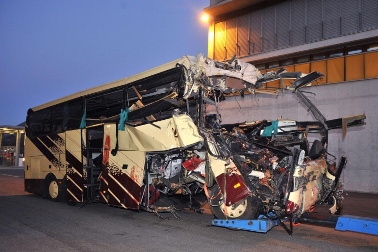 'The wreckage of a bus is seen after it crashed inside a motorway tunnel in Sierre, in the Swiss canton of Valais on March 14, 2012. Twenty-eight people, including 22 children, returning from a skiing