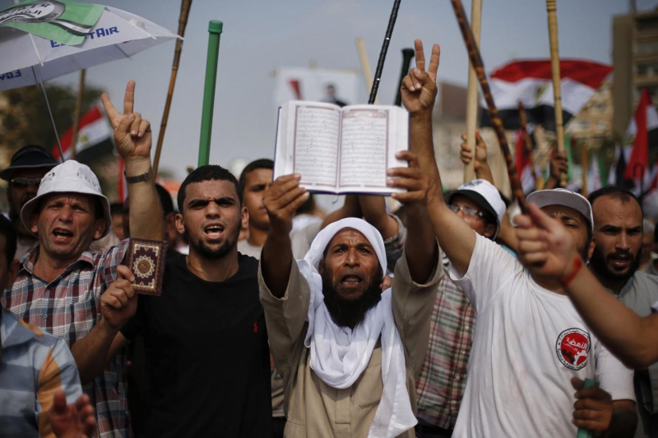 'Supporters of Egyptian President Mohamed Mursi hold copies of the Koran during a protest around the Raba El-Adwyia mosque square in Nasr City, in the suburb of Cairo June 30, 2013. Mass demonstration