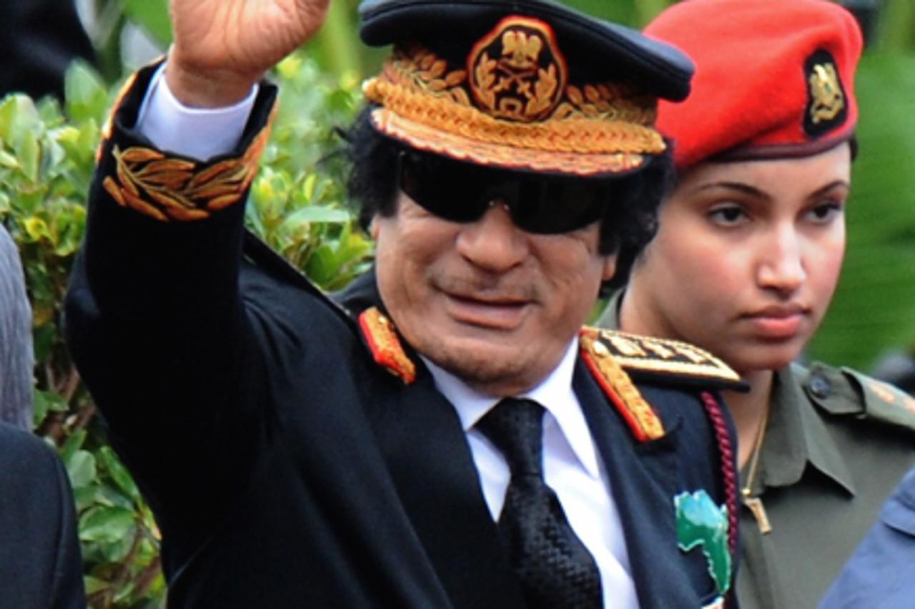 \'Libyan leader Muammar Gaddafi greets the crowd at the inauguration ceremony of South Africa\'s newly elected president Jacob Zuma in Pretoria on May 9, 2009. Zuma is the county\'s fourth President s