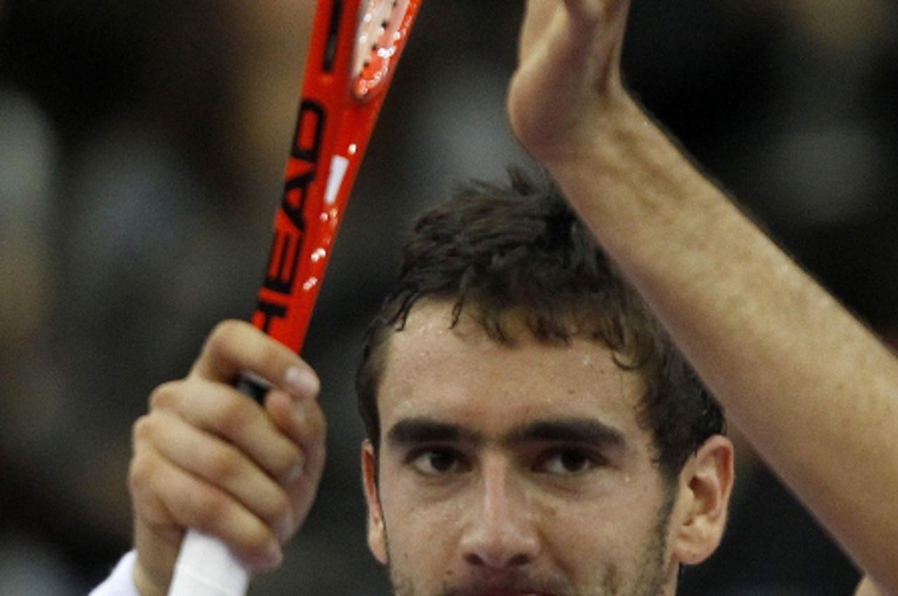 'Marin Cilic of Croatia celebrates his victory over Janko Tipsarevic of Serbia in their ATP St. Petersburg Open tennis tournament final match in St. Petersburg October 30, 2011.  REUTERS/Alexander Dem
