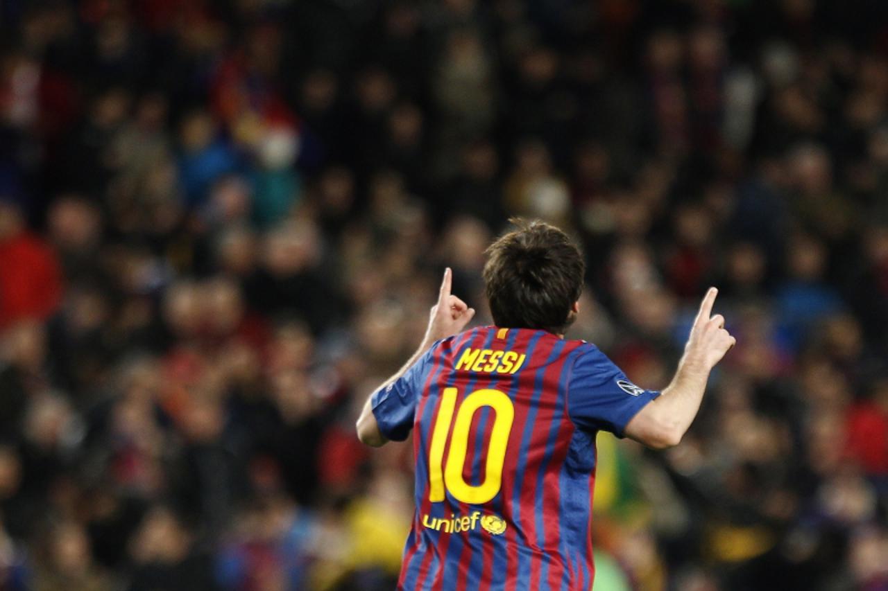 \'Barcelona\'s Lionel Messi celebrates after scoring a goal against Bayer Leverkusen during their Champions League last 16 second leg soccer match at Nou Camp stadium in Barcelona March 7, 2012.      
