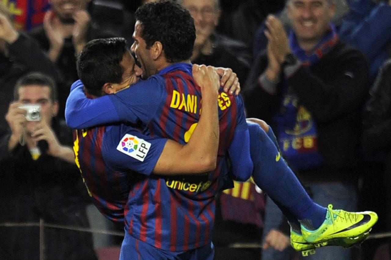'Barcelona\'s Chiliean forward Alexis Sanchez (L) celebrates with Barcelona\'s Brazilian defender Daniel Alves after scoring during the Spanish League football match between FC Barcelona and  Rayo Val