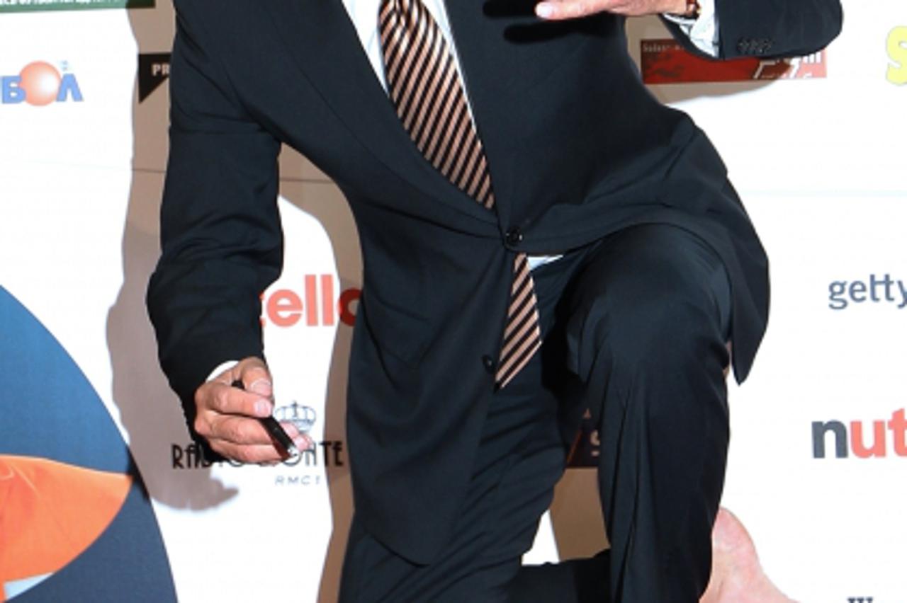 'German former football player Franz Beckenbauer signs his footprints on a slab of moulding compound on October 11, 2010 in Monaco during the 2010 Golden Foot Award. The Golden Foot award is an intern