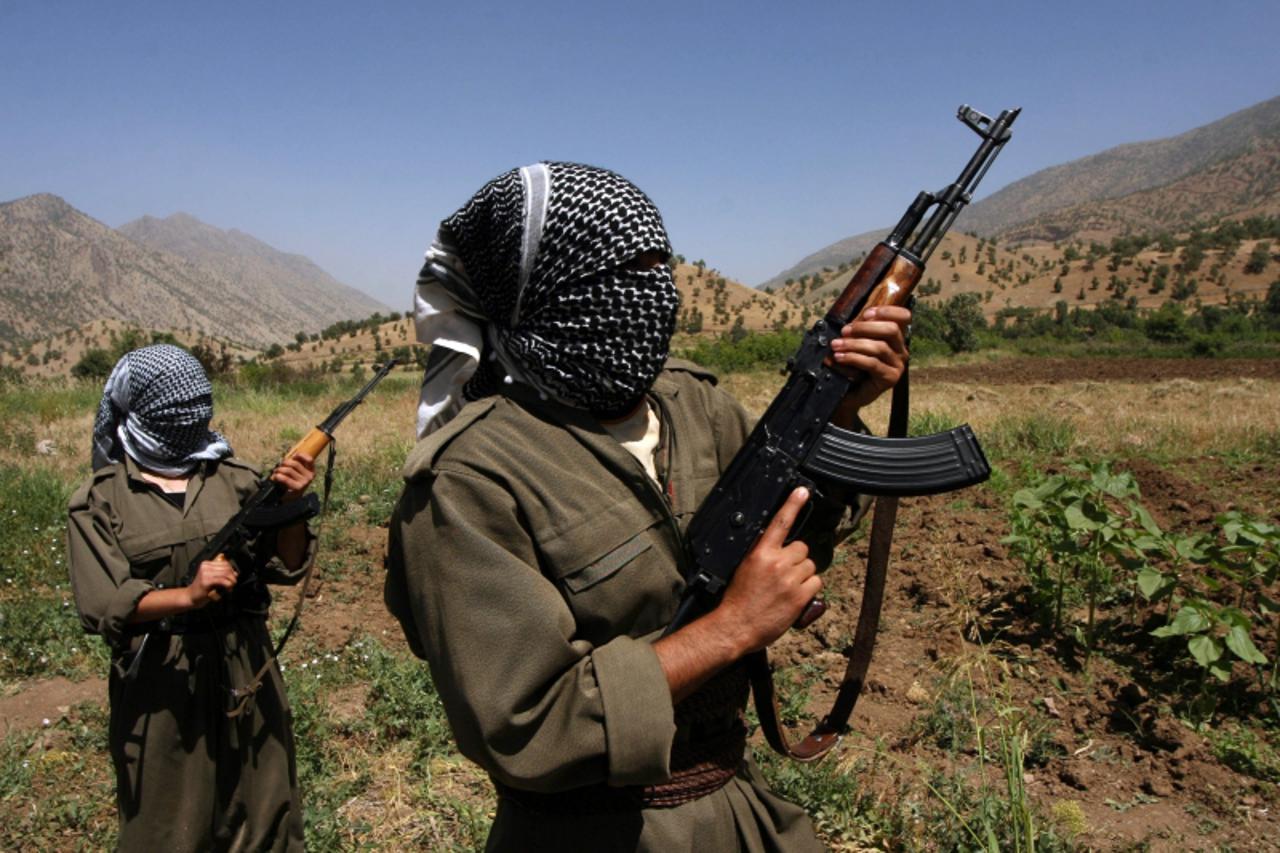 'This file photo taken on June 12, 2007 shows Kurdistan Workers\' Party (PKK) rebels patroling an area in the Iraqi part of Qandil Mountains near their headquarters on the Iraqi-Iranian-Turkish border