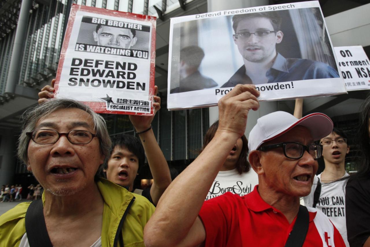 'Protesters in support of Edward Snowden, a contractor at the National Security Agency (NSA), chant slogans before marching to U.S. Consulate in Hong Kong in this June 13, 2013 file photo. Snowden lef