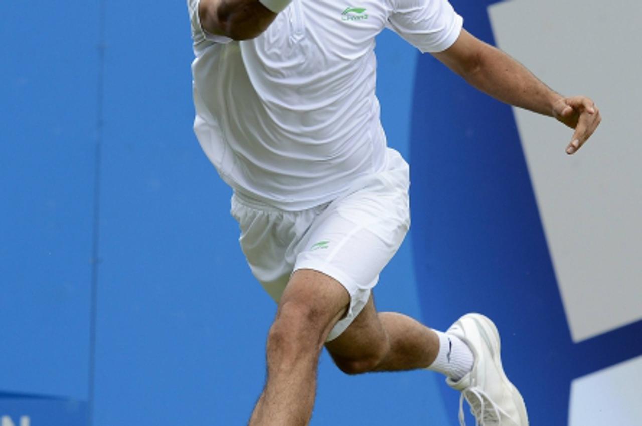 'Marin Cilic of Croatia hits a return to Sam Querrey of the U.S. during their men\'s singles tennis match at the Queen\'s Club tournament in London June 16, 2012.  REUTERS/Dylan Martinez  (BRITAIN - T