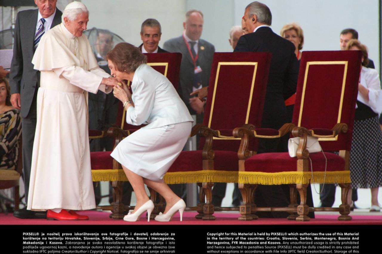'Pope Benedict XVI waves to the crowd surrounded by Queen Sofia of Spain and King Juan Carlos of Spain at the end of his visit to Spain for leading The World Youth Day 2011 at Barajas airport on Augus