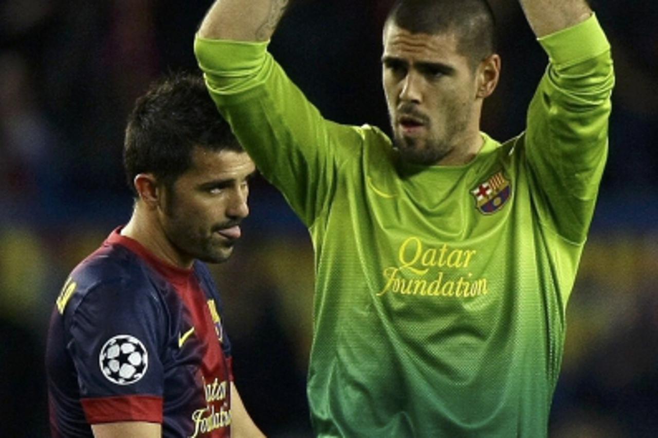 'Barcelona's goalkeeper Victor Valdes (R) and David Villa react as they leave the pitch at the end of their Champions League semi-final second leg soccer match against Bayern Munich at Camp Nou stadi