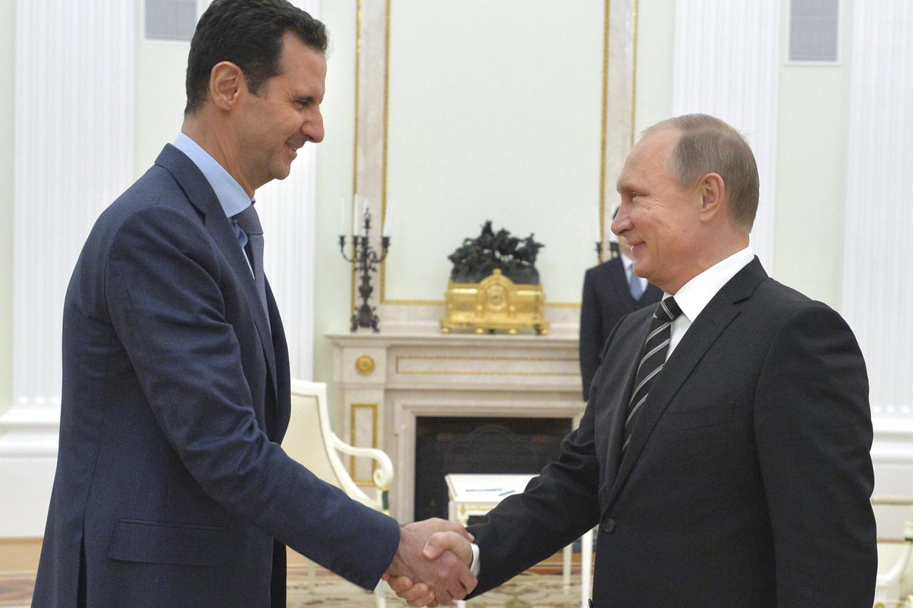 Russian President Vladimir Putin (R) shakes hands with Syrian President Bashar al-Assad during a meeting at the Kremlin in Moscow, Russia, October 20, 2015. Assad flew to Moscow on Tuesday evening to personally thank Putin for his military support, in a s