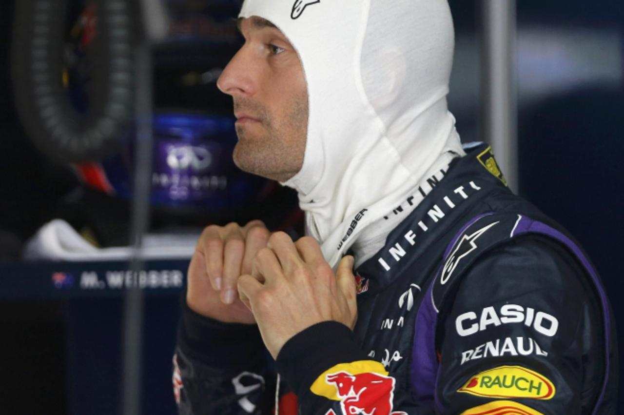 'Red Bull Formula One driver Mark Webber of Australia adjusts his balaclava during the third practice session of the Malaysian F1 Grand Prix at Sepang International Circuit outside Kuala Lumpur, March