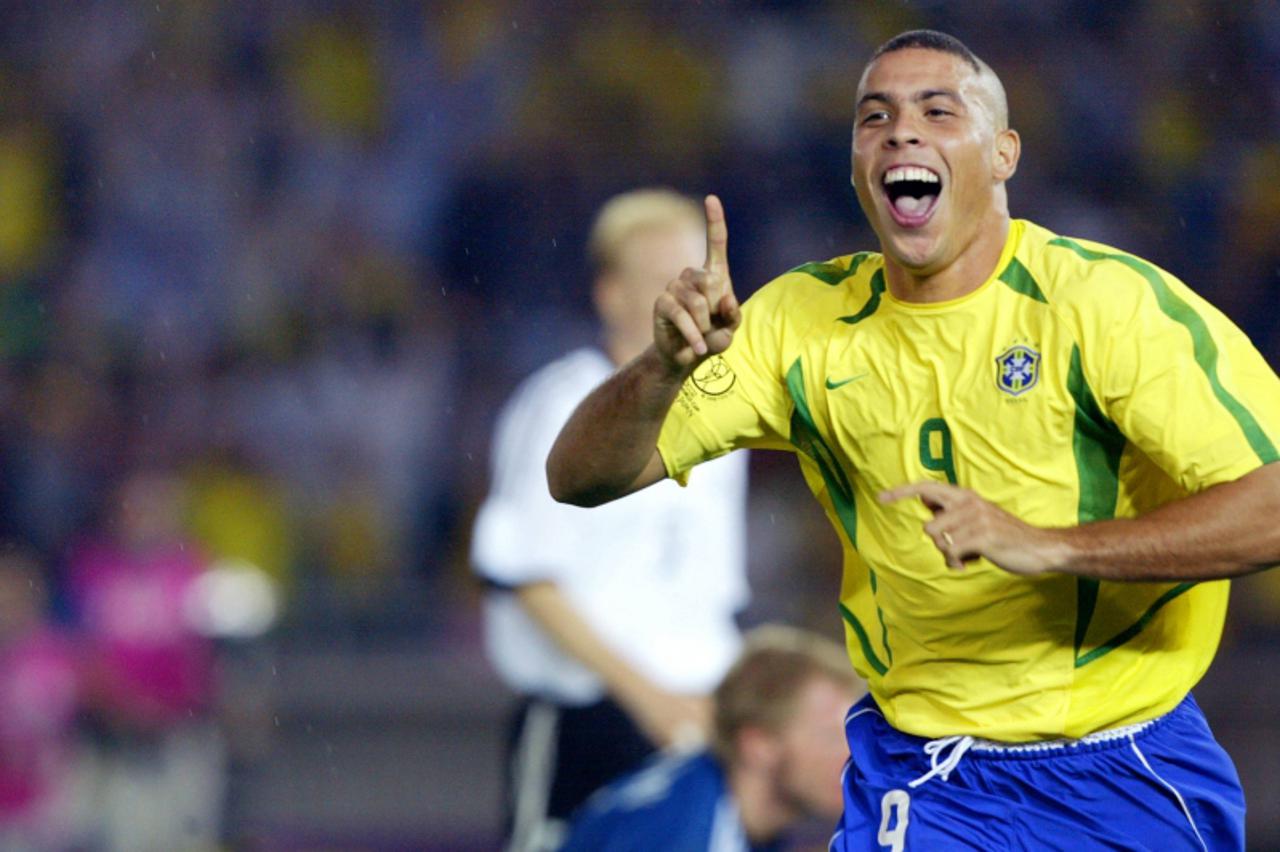 'Brazilian forward Ronaldo celebrates after scoring the second Brazilian goal 30 June 2002 during the Germany/Brazil final of the 2002 FIFA World Cup. Brazil won its fifth title beating Germany 2-0. A