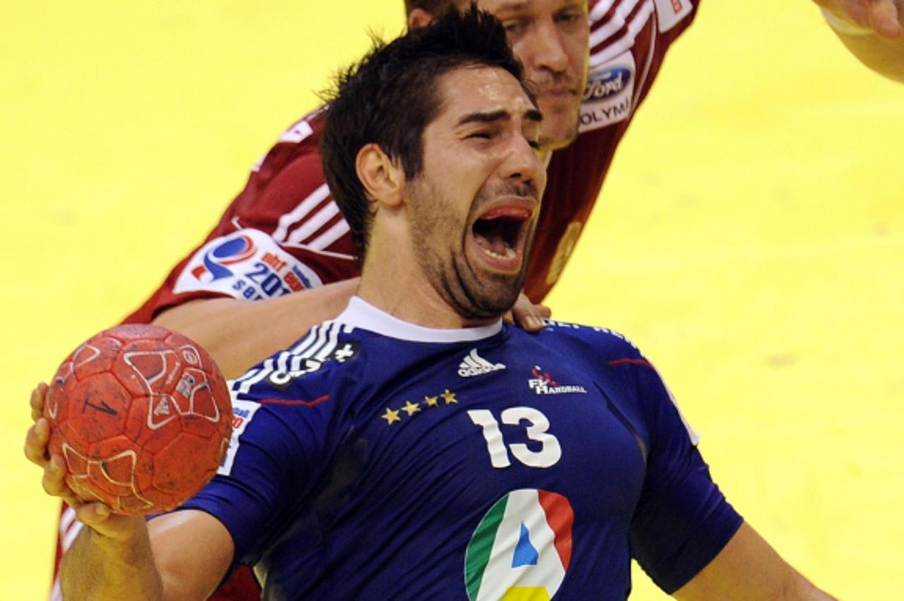 'French Nikola Karabatic (L) grimaces next to Hungarian Balazs Laluska (R) during the Men\'s EHF Euro 2012 Handball Championship match France vs Hungary at the sports hall in Novi Sad on January 20, 2