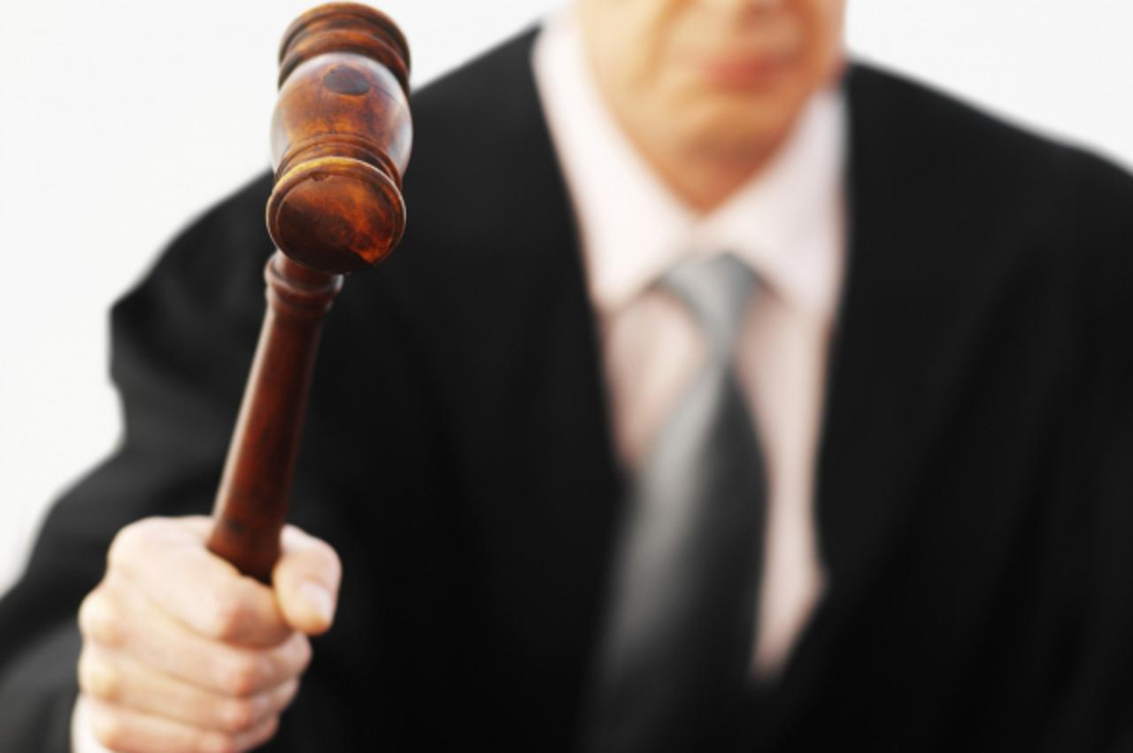 'Close-up of male judge banging gavel'