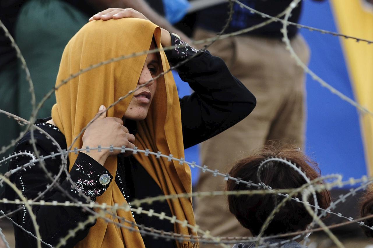 A migrant at Greece's border with Macedonia, waits to enter Gevgelija, Macedonia, August 22, 2015. Police and soldiers deployed along Macedonia's southern border with Greece struggled on Saturday to control the numbers of refugees and migrants, many of th