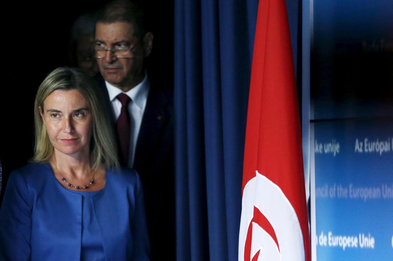 European Union foreign policy chief Federica Mogherini and Tunisia's Prime Minister Habib Essid (back) arrive to address a joint news conference during a European Union foreign ministers meeting in Brussels, Belgium, July 20, 2015. REUTERS/Francois L