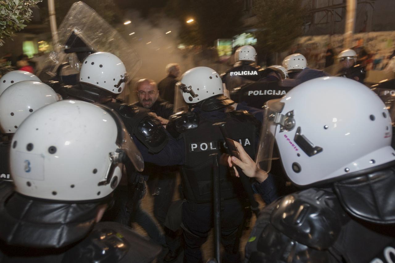 Riot policemen push demonstrators while attempting to disperse them outside the parliament building in the capital Podgorica, Montenegro, October 17, 2015. Montenegro's police used teargas on Saturday to disperse hundreds of anti-government protesters out