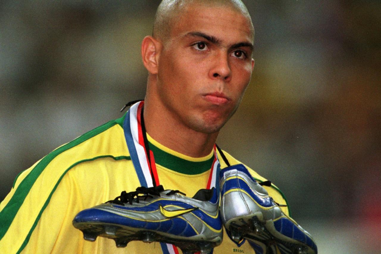 'Brazilian soccer star Ronaldo has his shoes hanging around his neck as he watches the awarding ceremony for victorious team France after the French national team defeated Brazil 3-0 in the 1998 Socce