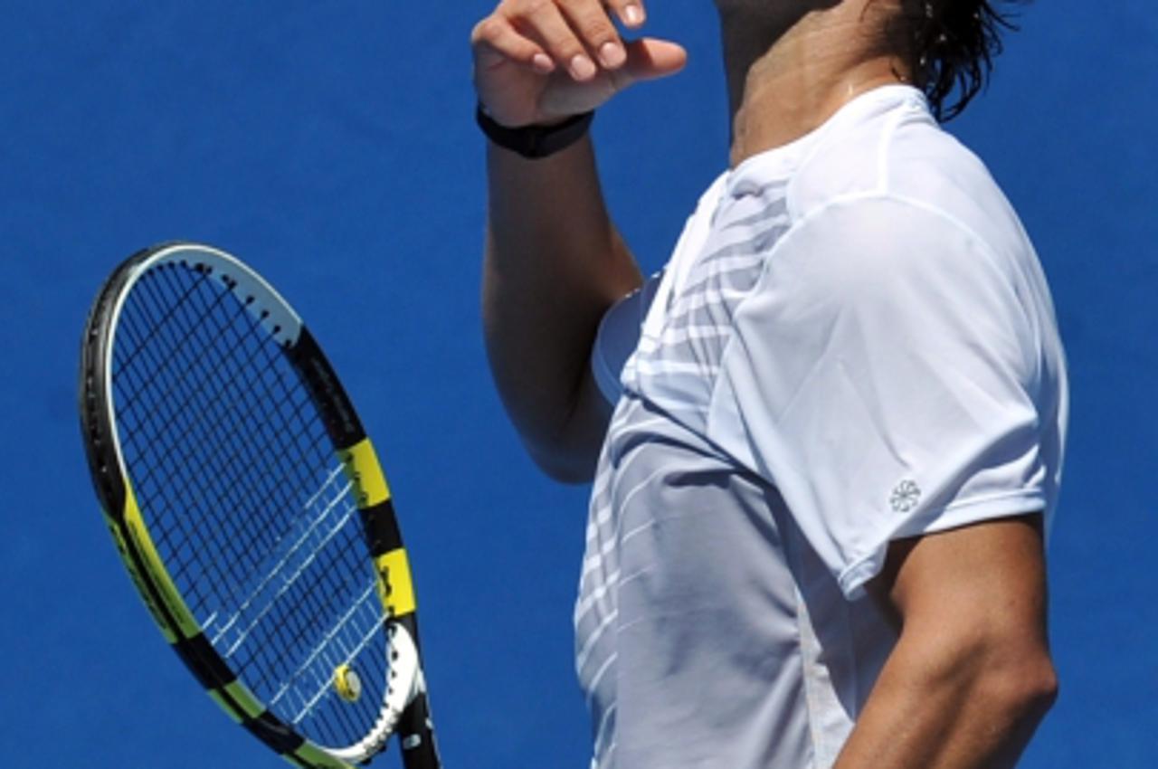 'Rafael Nadal of Spain reacts during a training session ahead of the 2012 Australian Open tennis tournament in Melbourne on January 15, 2012.  The tennis season's first Grand Slam of the year will t