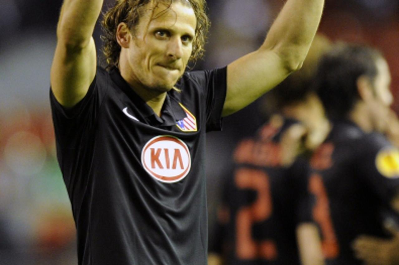\'Atletico Madrid\'s Uruguayan forward Diego Forlan celebrates at the final whistle after his team had knocked out Liverpool on away goals during their UEFA Europa League Semi Final second leg footbal