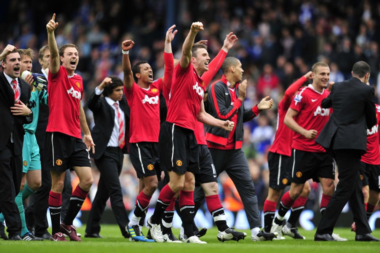 'Manchester United players celebrate on the final whistle in the English Premier League football match between Blackburn Rovers and Manchester United at Ewood Park, Blackburn, north-west England on Ma