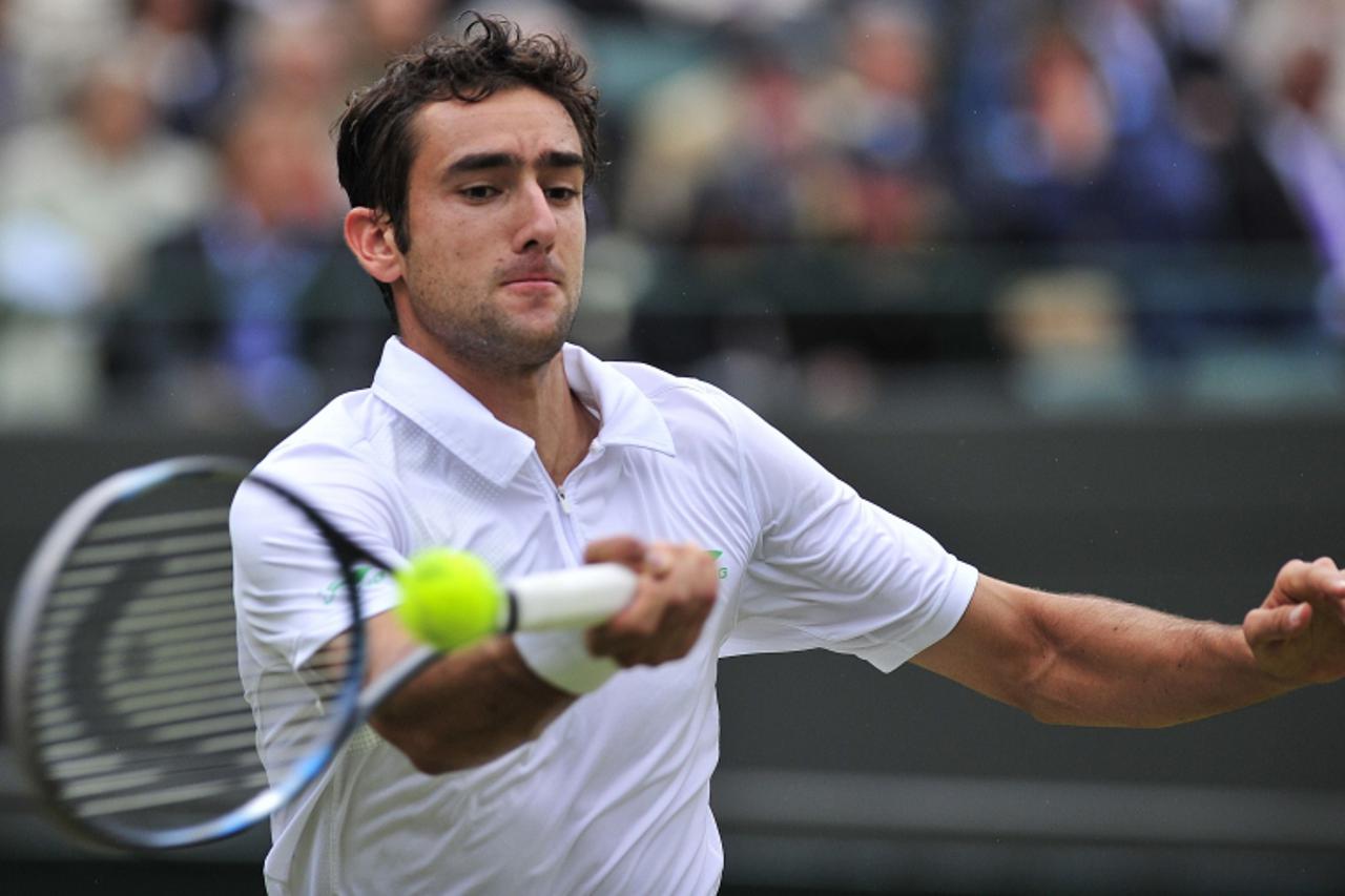 'Croatia\'s Marin Cilic plays a forehand shot during his fourth round men\'s singles match against Britain\'s Andy Murray on day seven of the 2012 Wimbledon Championships tennis tournament at the All 