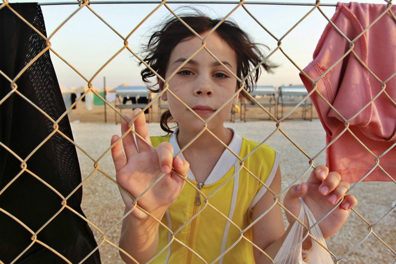 'RNPS IMAGES OF THE YEAR 2012 - A Syrian refugee is pictured at the Al Zaatri refugee camp in the Jordanian city of Mafraq, near the border with Syria, July 31, 2012. Jordan opened the camp with 2,000