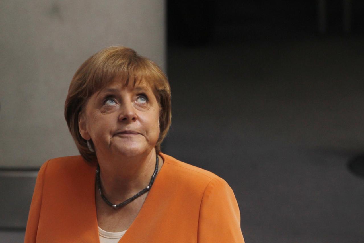 'German Chancellor Angela Merkel arrives at a session of the Bundestag, the lower house of parliament, that will vote on a Spanish bank aid package in Berlin, July 19, 2012.  Merkel's authority withi
