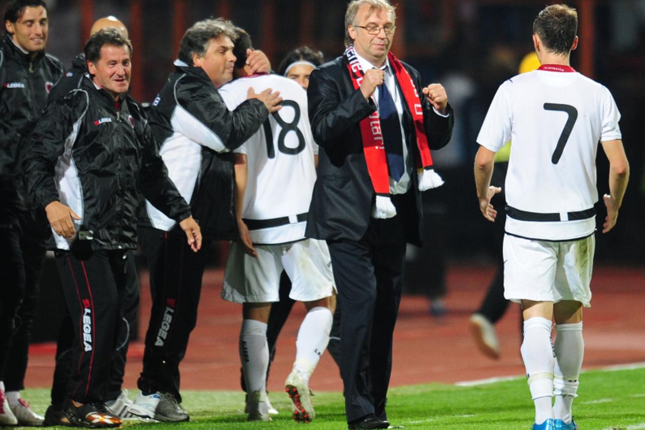\'Albania\' s coach Josip Kuze (C) celebrates with team players at the end of their Euro 2012 qualifying football match against Romania in Piatra-Neamt city, some 350km north of Bucharest, on Septembe