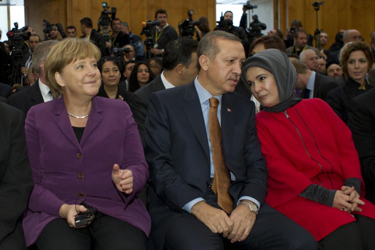 \'German Chancellor Angela Merkel (L), Turkey\'s Prime Minister Recep Tayyip Erdogan (C) and his wife Emine (R) attend a a ceremony to celebrate 50 years of Turkish guest workers in Germany on Novembe