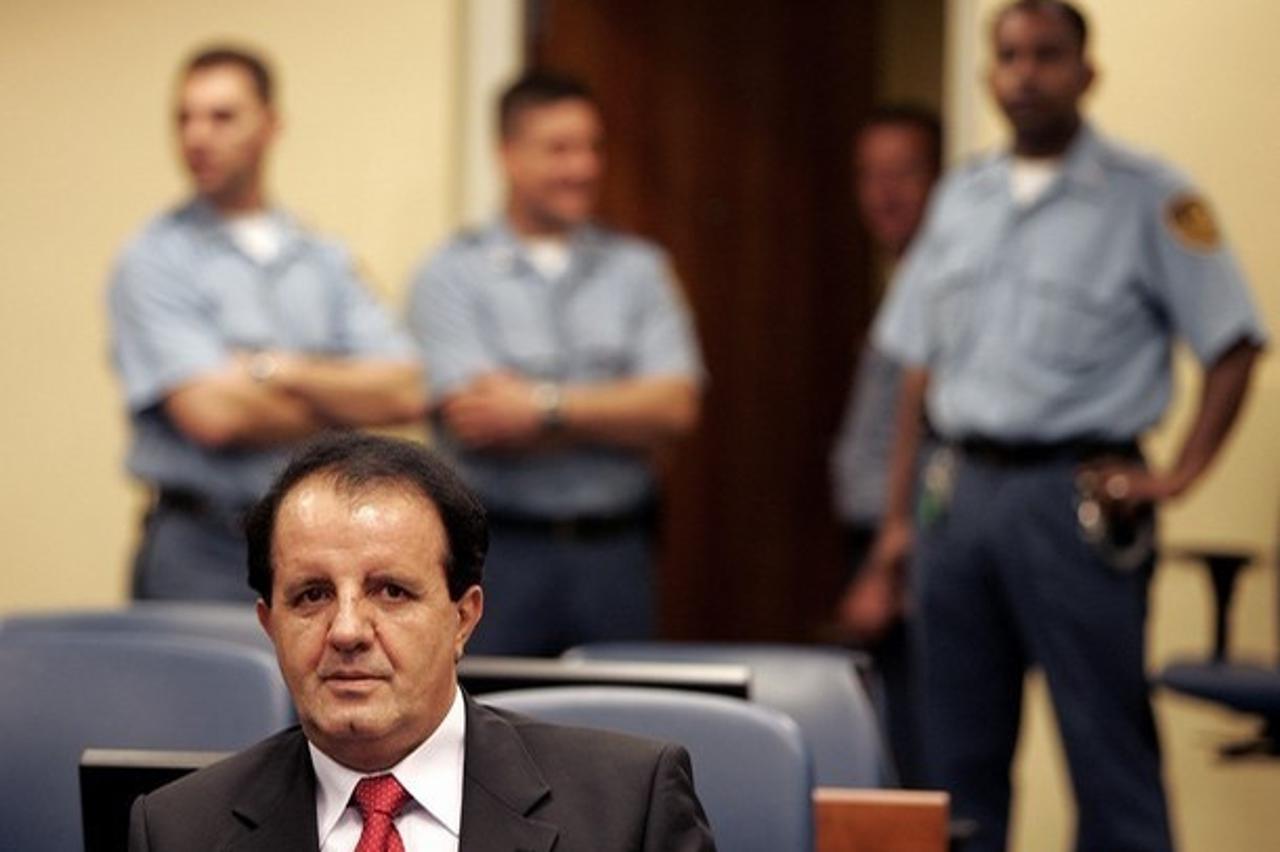 'Former Bosnian Muslim army commander Sefer Halilovic and his lawyer Guenael Mettraux (not pictured) await the appeal judgement in the courtroom of the Yugoslav war crimes tribunal in The Hague, the N