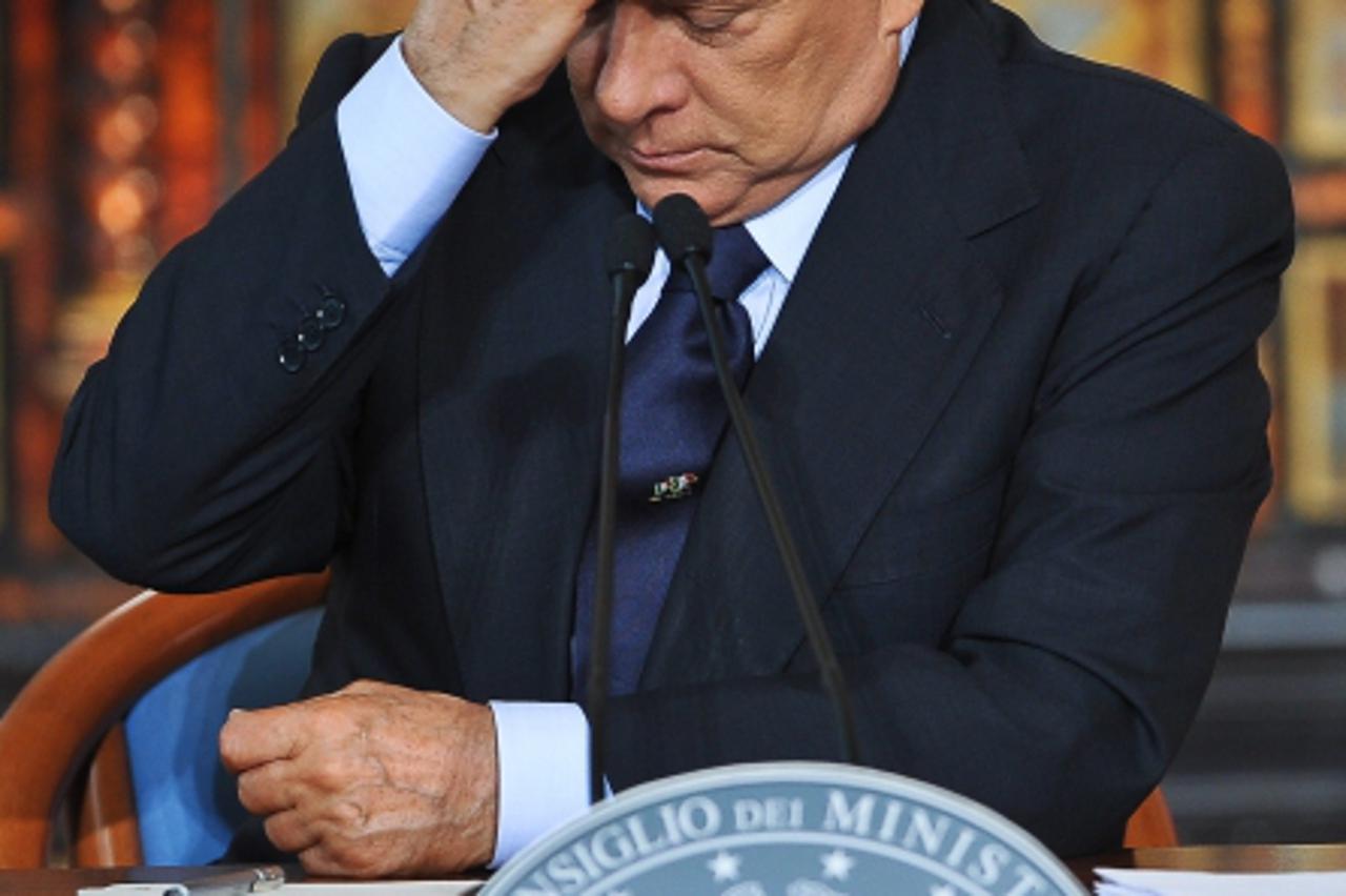 'This file picture taken on December 23, 2010 shows Italy\'s Prime Minister Silvio Berlusconi giving his end of the year press conference at Villa Madama in Rome. Global stock markets turned lower on 